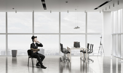 Elegant businessman read old book . Mixed media