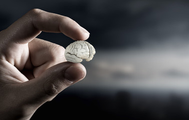 Small brain between fingers . Mixed media