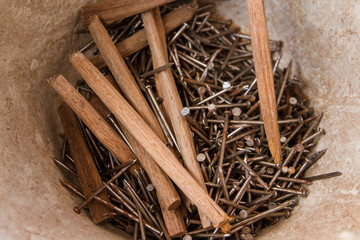 Pile of nails in a plastic bucket.