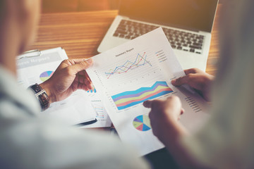 Businessman talking business with his secretary sitting at office.