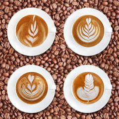 Latte art coffee on roasted coffee beans background