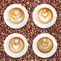 Latte art coffee on roasted coffee beans background