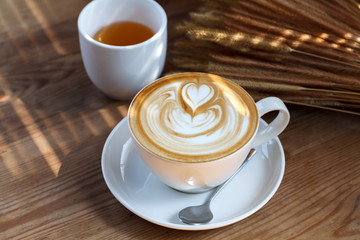 Close-up latte art coffee on wood background..