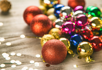 studio shot of group of colorful baubles on wooden table.