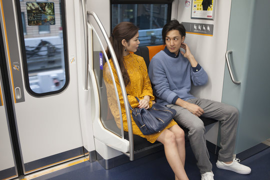Young couple are chatting on a train