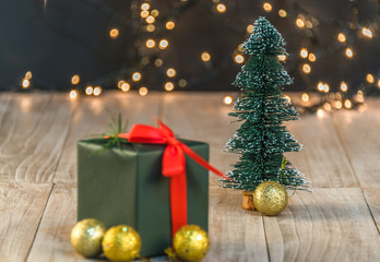Fototapeta na wymiar christmas decorations and green present on wood.
