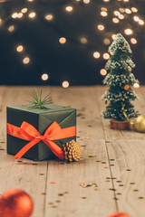 Fototapeta na wymiar christmas decorations and green present on wood.
