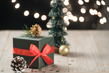 christmas decorations and green present on wood.
