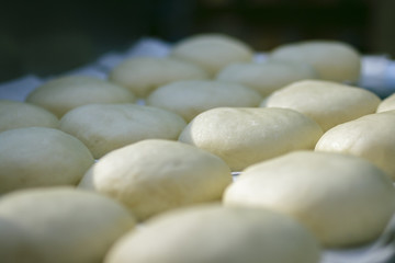 Fototapeta na wymiar Preparation of donuts. formed dough