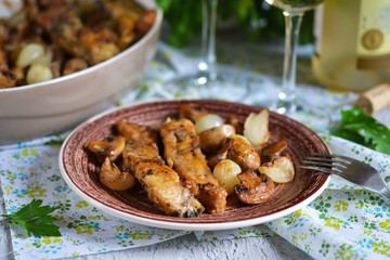 Baked fish with mushrooms, potatoes and onions 