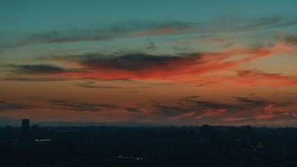Obraz premium Dramatic red scenery of the city silhouette at sunset
