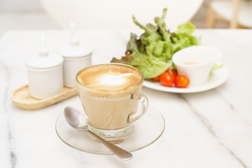 coffee latte glass cup with salad on white marble table