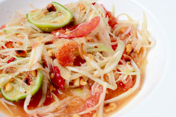 Green Papaya Salad (Som tum Thai) on table. Thai cuisine spicy delicious.