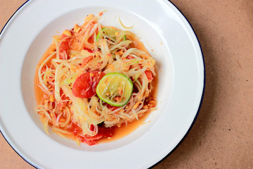 Green Papaya Salad (Som tum Thai) on table. Thai cuisine spicy delicious.