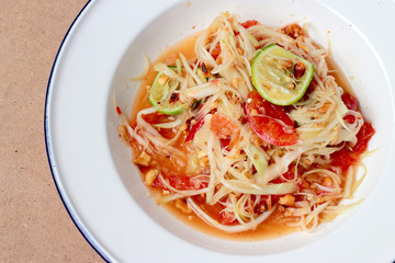 Green Papaya Salad (Som tum Thai) on table. Thai cuisine spicy delicious.