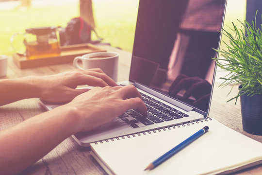 Young Business Man Hand Holding Cup Coffee And Using Laptop Comp