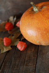 pumpkin and candle on old wooden