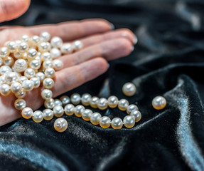 Pearl necklace on the woman's hand