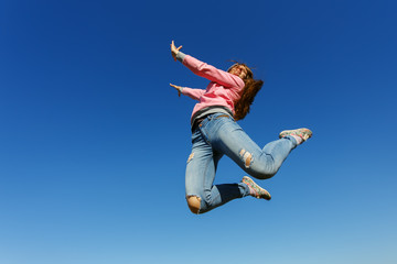 Fototapeta na wymiar Young beautiful woman dancer jumping