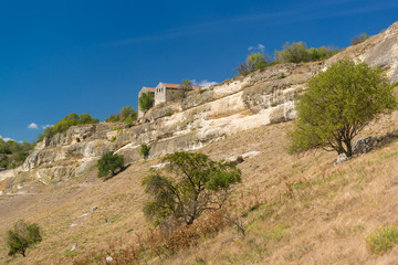 Fototapeta na wymiar Cupations the southern slopes of the plateau and the medieval Karaite kenesa of the city-fortress Chufut-Kale. Bakhchysaray, Crimea
