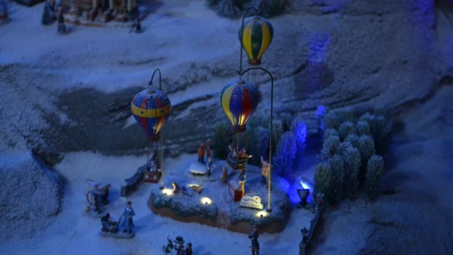Fairy miniature village with multi-colored balloons. Miniature fairytale town with balloons and snow toy passers. Dreamland handmade. The exhibition of the national economy. Ukraine. Kiev. 01/24/2016