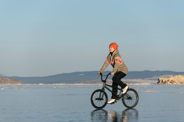 Girl on a bmx on ice.