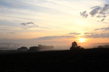 Dawn over rural countryside