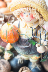 Farmer figurine with pumpkin and nuts. Halloween decoration. 