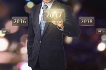 Businessman hand touching 2017 number