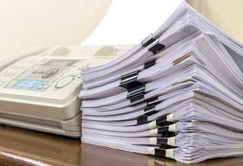 Stacks of paper and fax machine