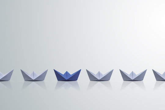 uniqueness concept, paper boat outstanding from the others 