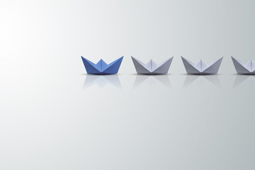 uniqueness concept, paper boat outstanding from the others 