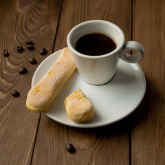 Cup of hot espresso and cookies