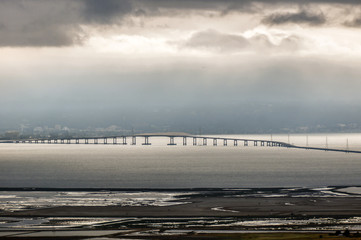San Mateo-Hayward Bridge and Foggy San Francisco Peninsula, California, USA. High angle view of San Mateo Bridge and Foster City in the background from East Bay hills. © Yuval Helfman