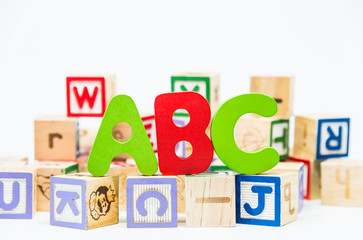 ABC word on wooden block and white background with selective focus