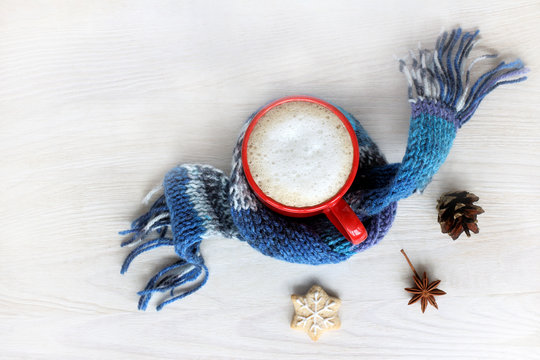 Holiday Breakfast With Aroma Christmas/ Mug With A Cappuccino In A Warm Winter Scarf On A Light Table Top View 