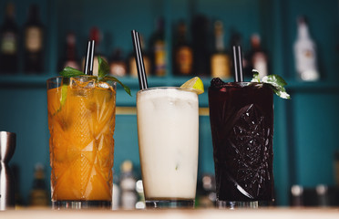 Creative exotic alcohol cocktails in night club bar