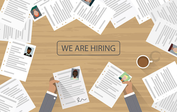 We are hiring written on office desk