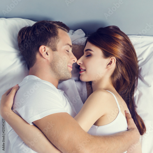 Young Sleeping And Hugging On The Bed In Bedroom Stock Photo Young Sleeping And Hugging On The Bed In Bedroom