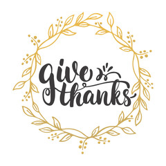 Give thanks - lettering calligraphy phrase with leaves on the background with golden wreath. Autumn Thanksgiving Day greeting card.