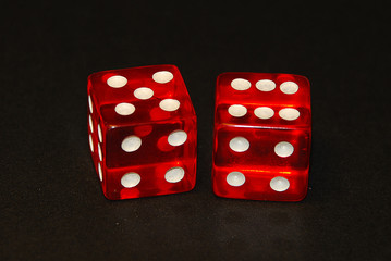 two dice on a black desk, result eleven (11), five (5) and six (