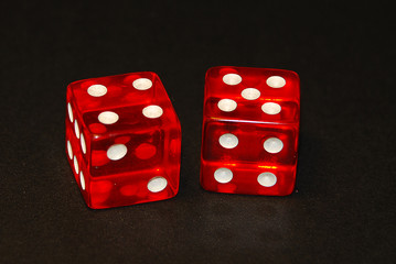 two dice on a black desk, result nine (9), four (4) and five (5)