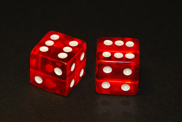 two dice on a black desk, result twelve (12), doublets of six (6