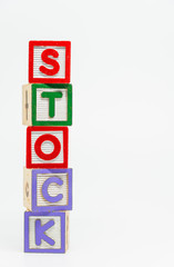STOCK word wooden block arrange in vertical style on white background and selective focus