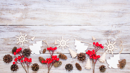 Christmas or New Year background: fur-tree, branches, gifts, colored glass balls, decoration and cones on wooden background