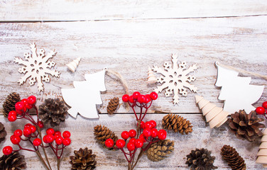 Christmas or New Year background: fur-tree, branches, gifts, colored glass balls, decoration and cones on wooden background