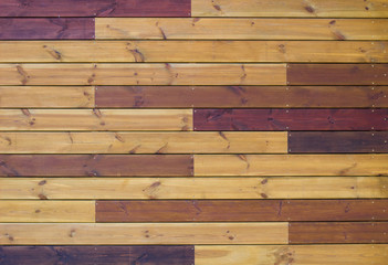 Wooden background of gorizontal yellow and brown pallets