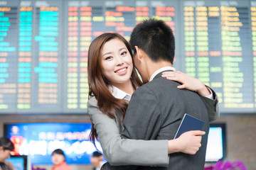 asian lovers with hug in modern airport