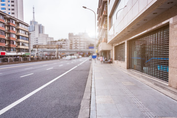 Obraz premium empty asphalt road through modern city.