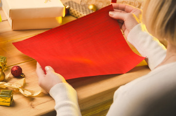 Obraz na płótnie Canvas Christmas and Holidays. Woman create presents for you.